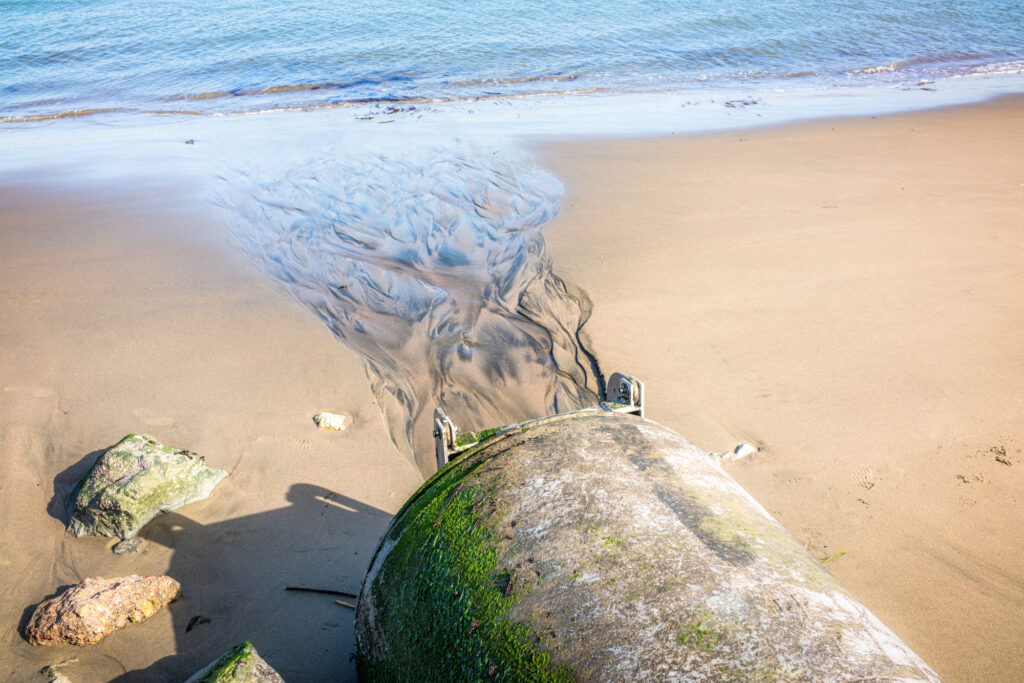 A stormwater pipe on a beach side