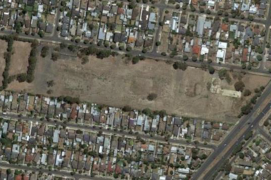 google earth image of large vacant land nestled in residential area