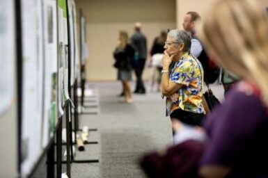 man looking at poster