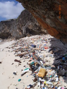 Debris littered across a beach on Christmas Island.