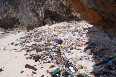 Debris littered across a beach on Christmas Island.